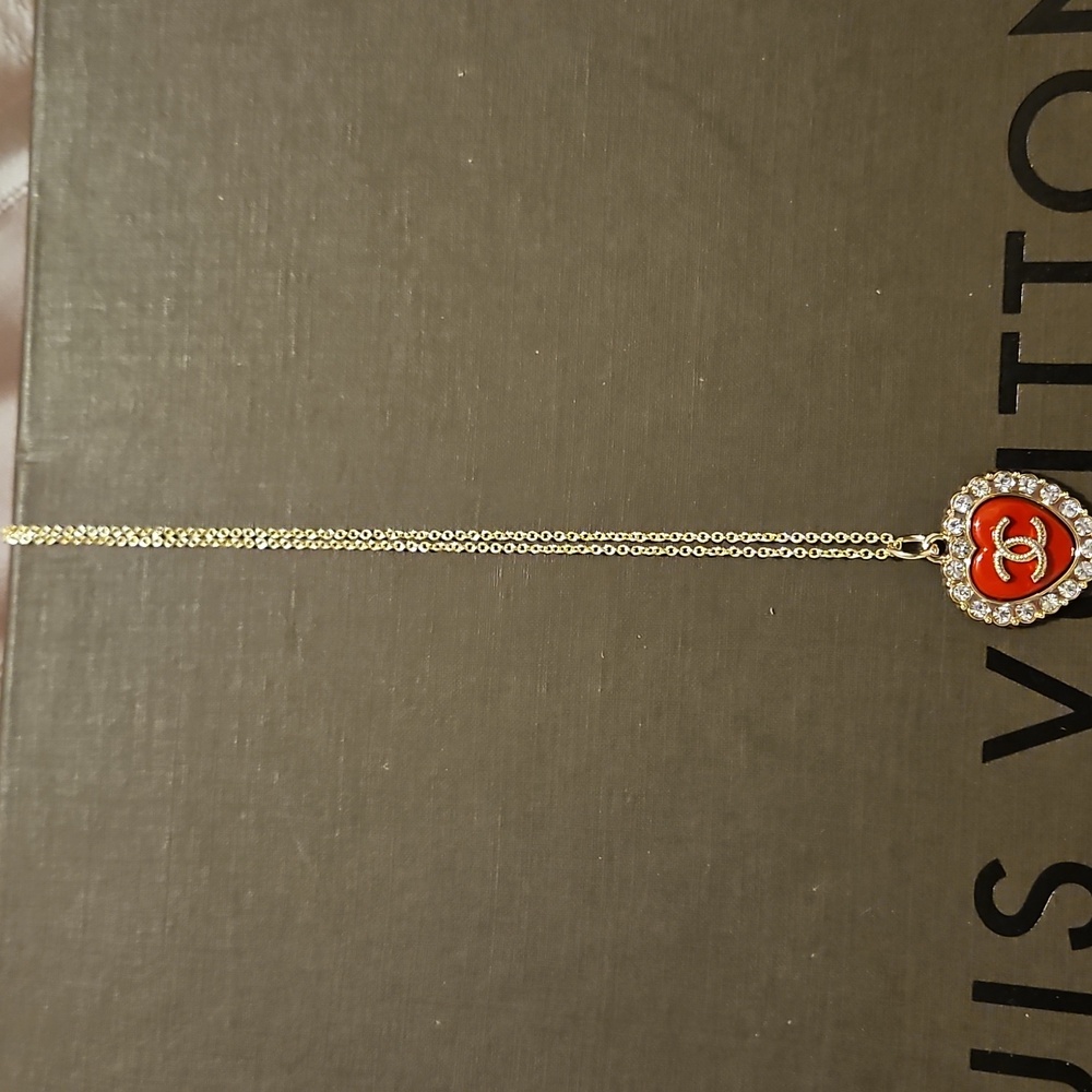 CHANEL Gold Necklace with Red Heart Pendant